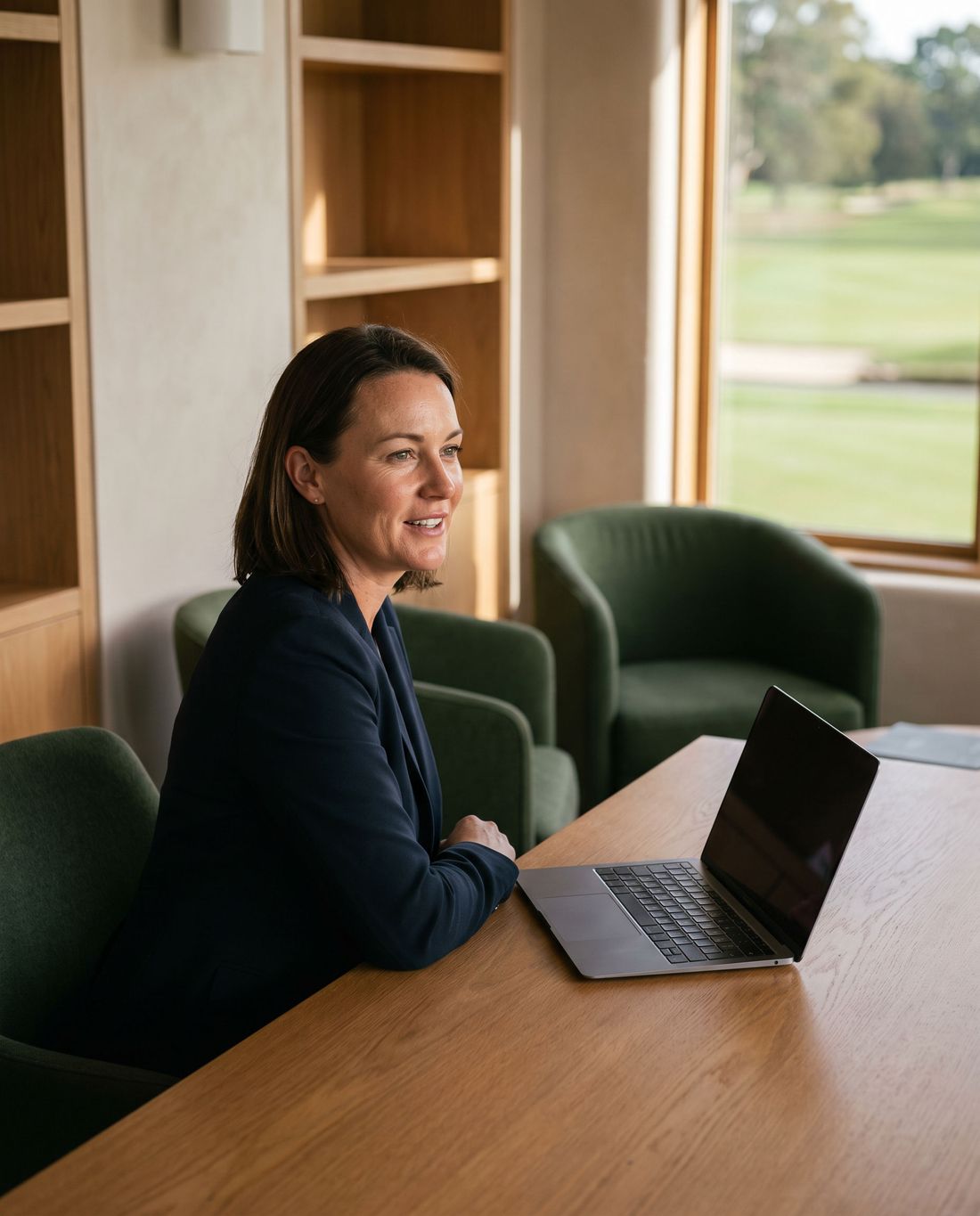 A club controller at her desk in a modern clubhouse office.